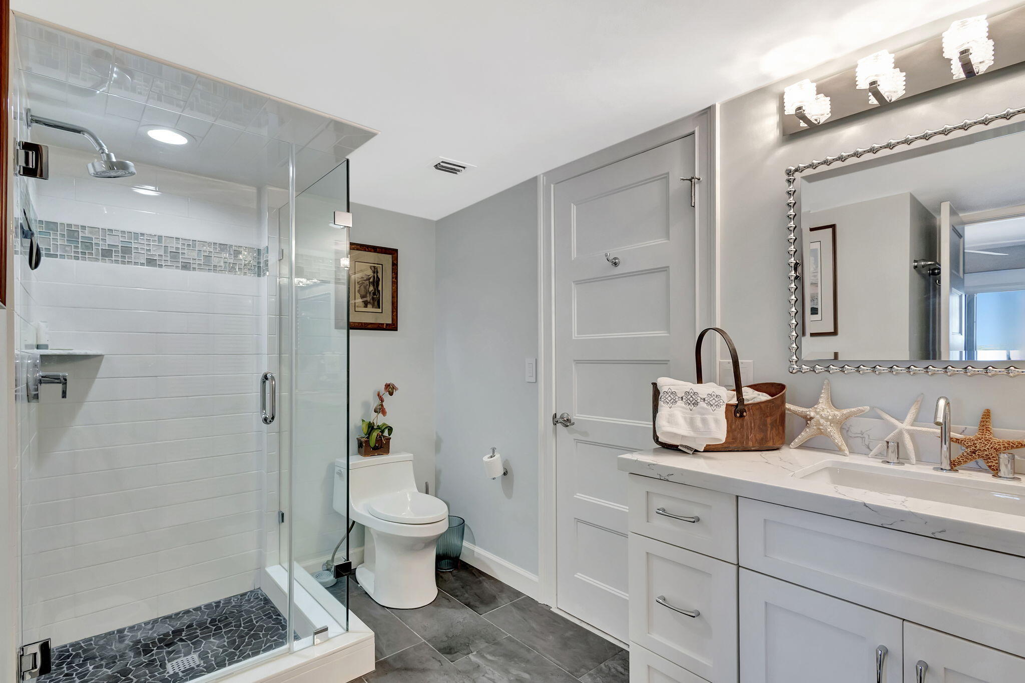 16910 Bay Street, Unit E503 Jupiter, FL 33477 - Photo 7 of 33 a bathroom with a sink a toilet and shower