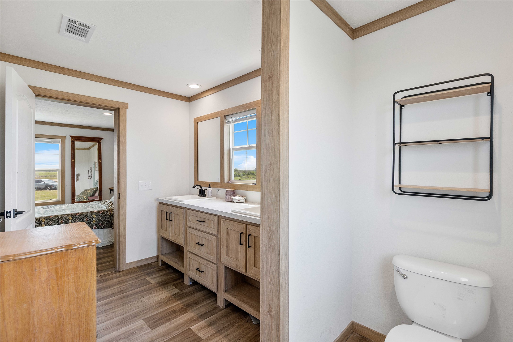 21550 Wilber Road Winnie, TX 77665 - Photo 20 of 28 a bathroom with a toilet sink and mirror