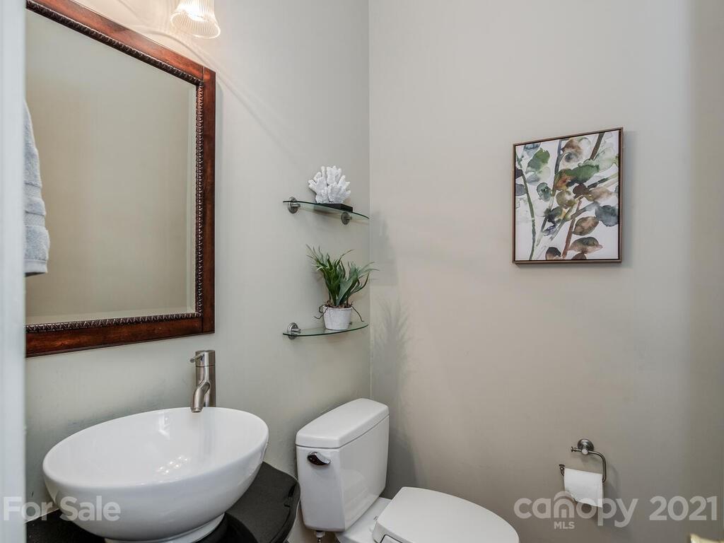 4626 Binfords Ridge Road Charlotte, NC 28226 - Photo 11 of 42 a bathroom with a toilet a sink and mirror