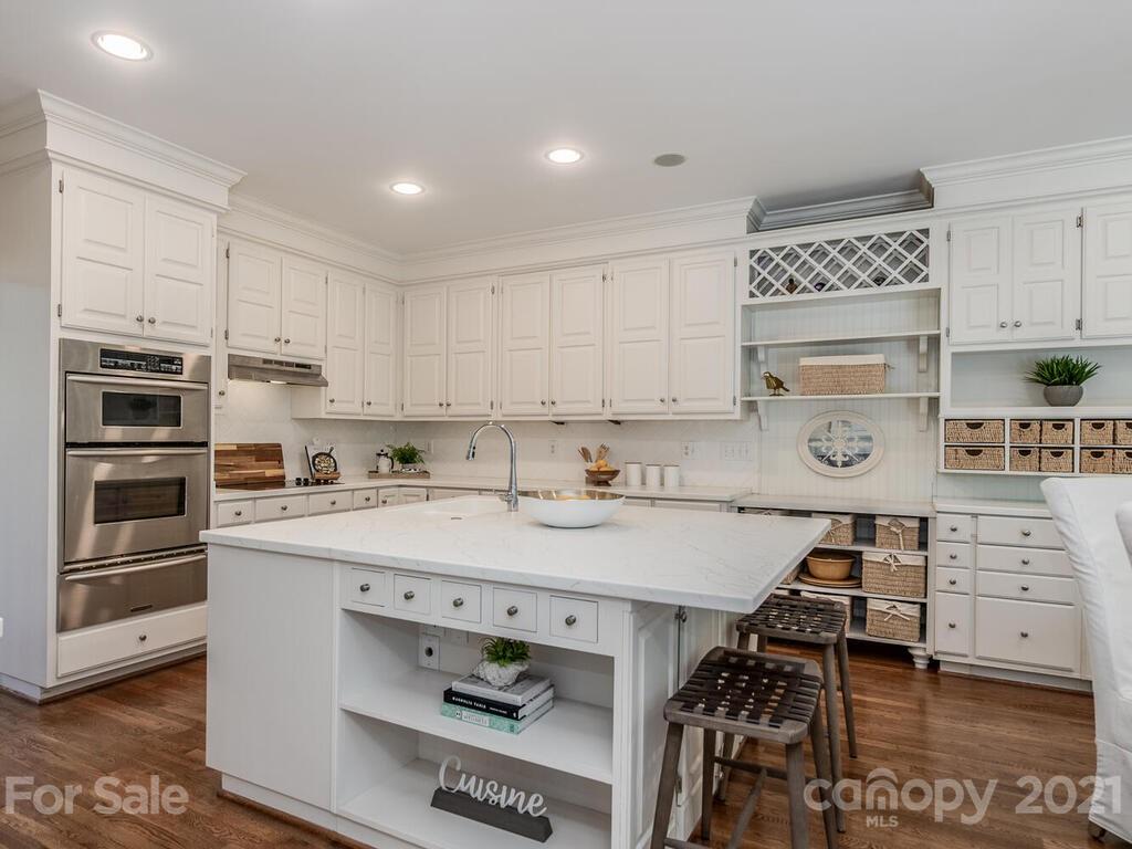 4626 Binfords Ridge Road Charlotte, NC 28226 - Photo 12 of 42 a kitchen with stainless steel appliances a stove a sink and cabinets