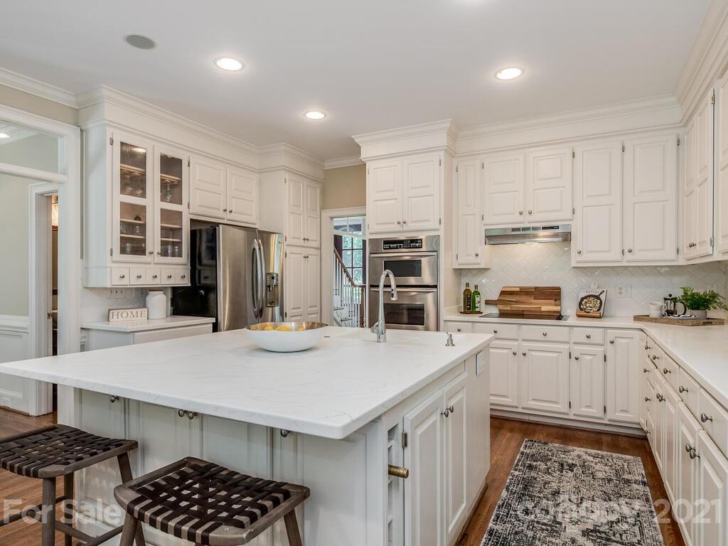 4626 Binfords Ridge Road Charlotte, NC 28226 - Photo 13 of 42 a kitchen with stainless steel appliances a stove a sink cabinets and a refrigerator