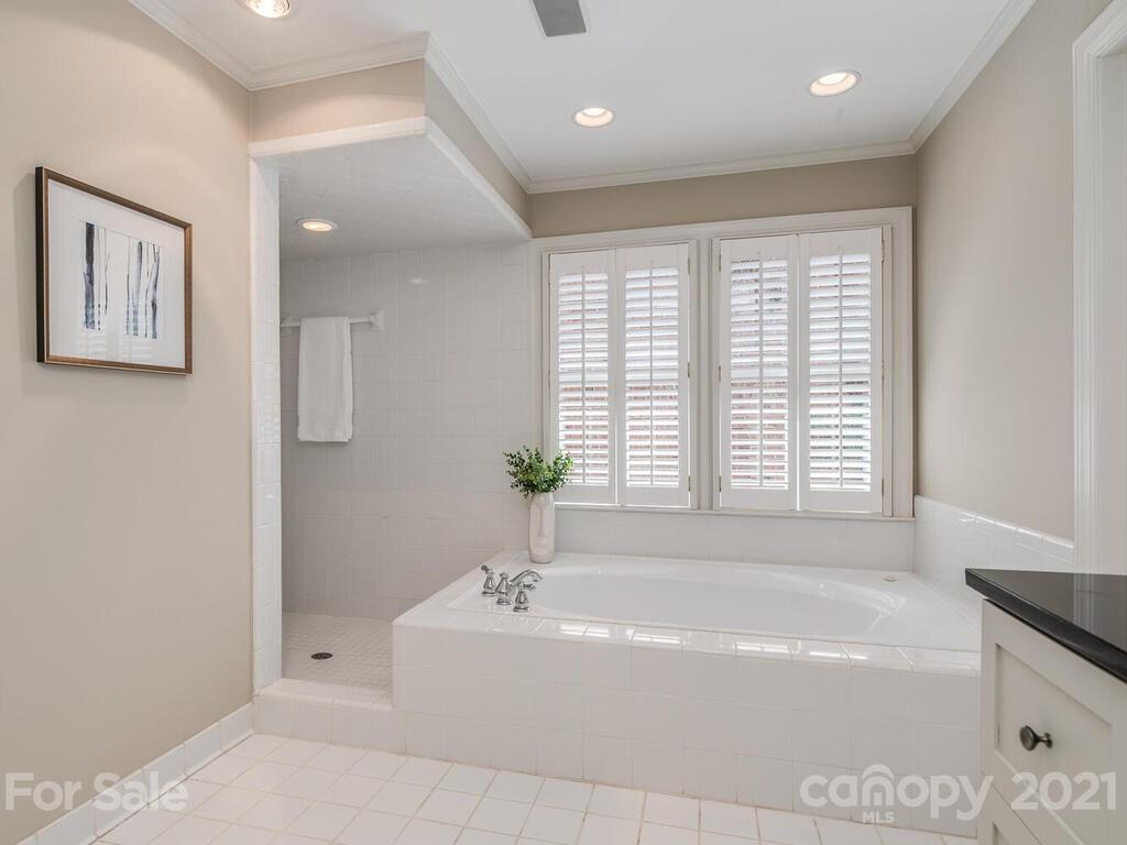 4626 Binfords Ridge Road Charlotte, NC 28226 - Photo 20 of 42 a spacious bathroom with a bathtub and shower