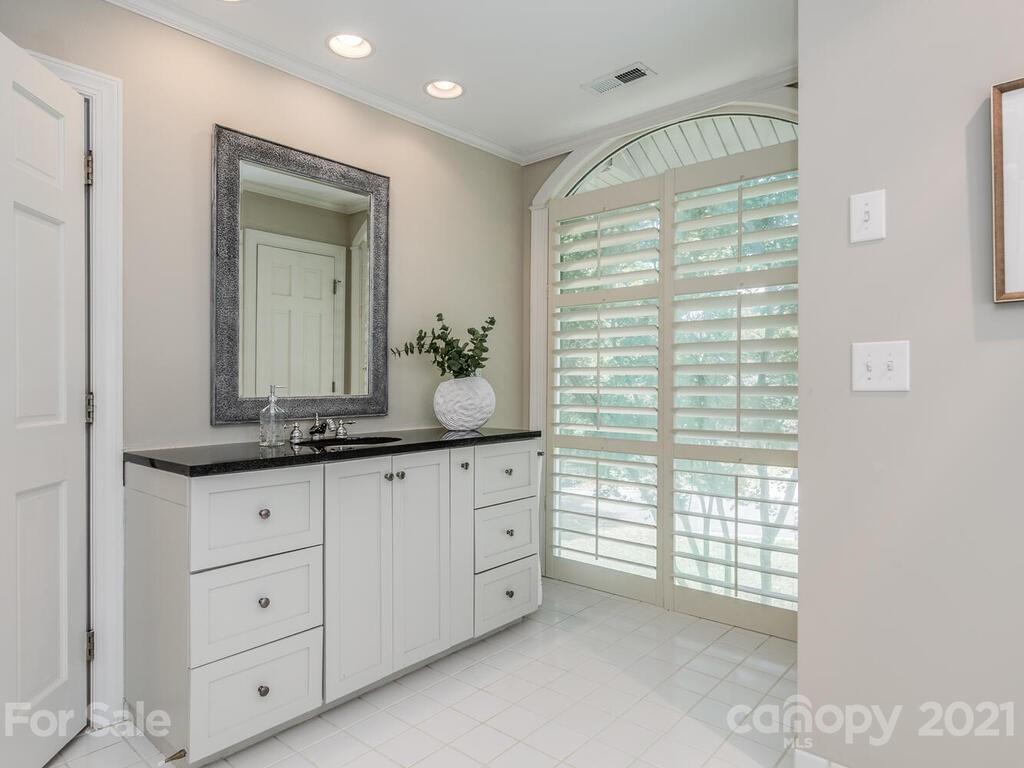 4626 Binfords Ridge Road Charlotte, NC 28226 - Photo 22 of 42 a bathroom with a granite countertop sink mirror and next to a window