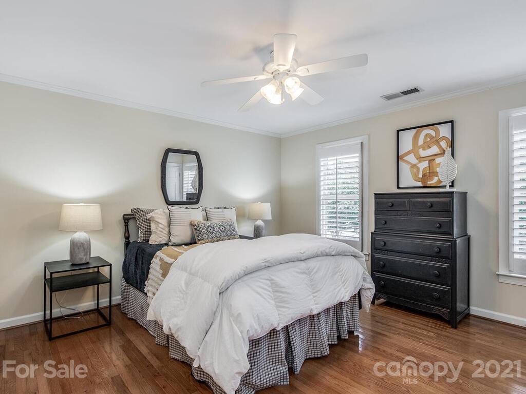 4626 Binfords Ridge Road Charlotte, NC 28226 - Photo 23 of 42 a bedroom with a bed and a chandelier