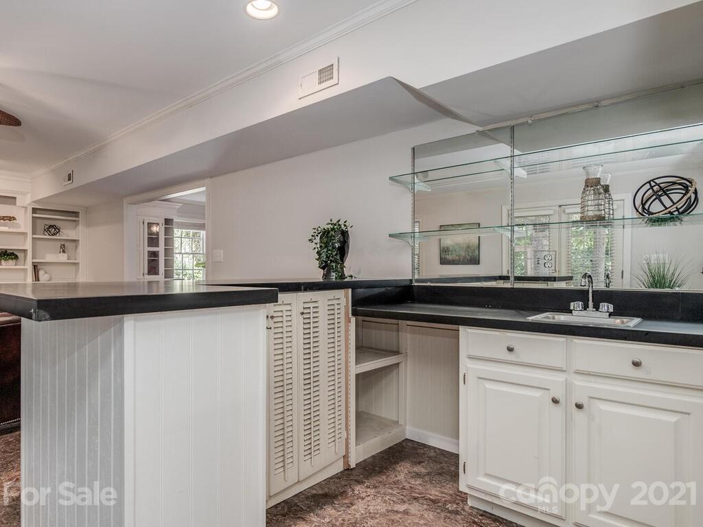 4626 Binfords Ridge Road Charlotte, NC 28226 - Photo 34 of 42 a kitchen with granite countertop a sink and cabinets