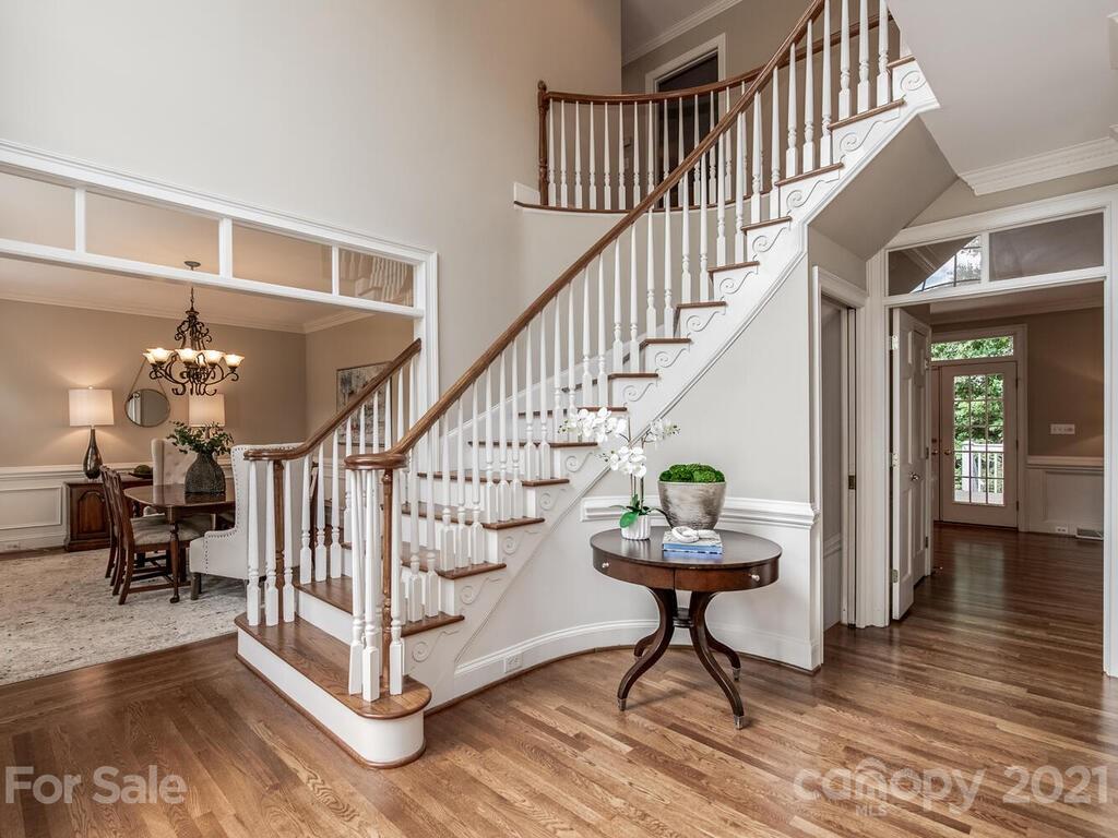 4626 Binfords Ridge Road Charlotte, NC 28226 - Photo 5 of 42 a view of staircase with lots of frames and flower couches