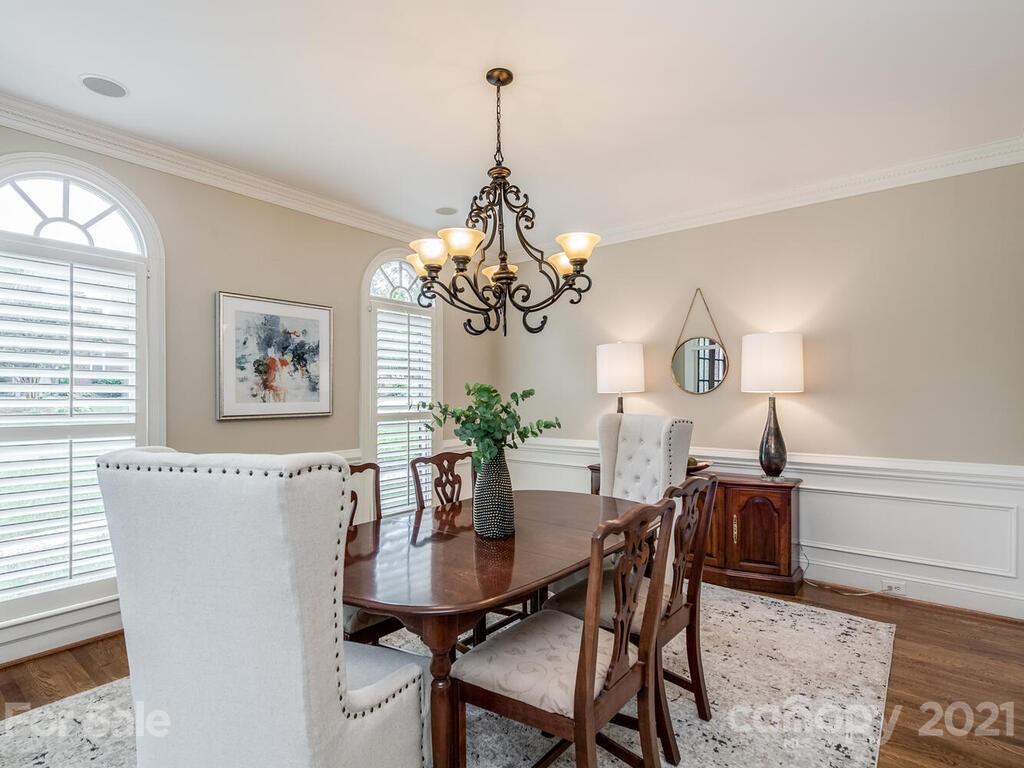 4626 Binfords Ridge Road Charlotte, NC 28226 - Photo 6 of 42 a dining room with furniture a chandelier and wooden floor
