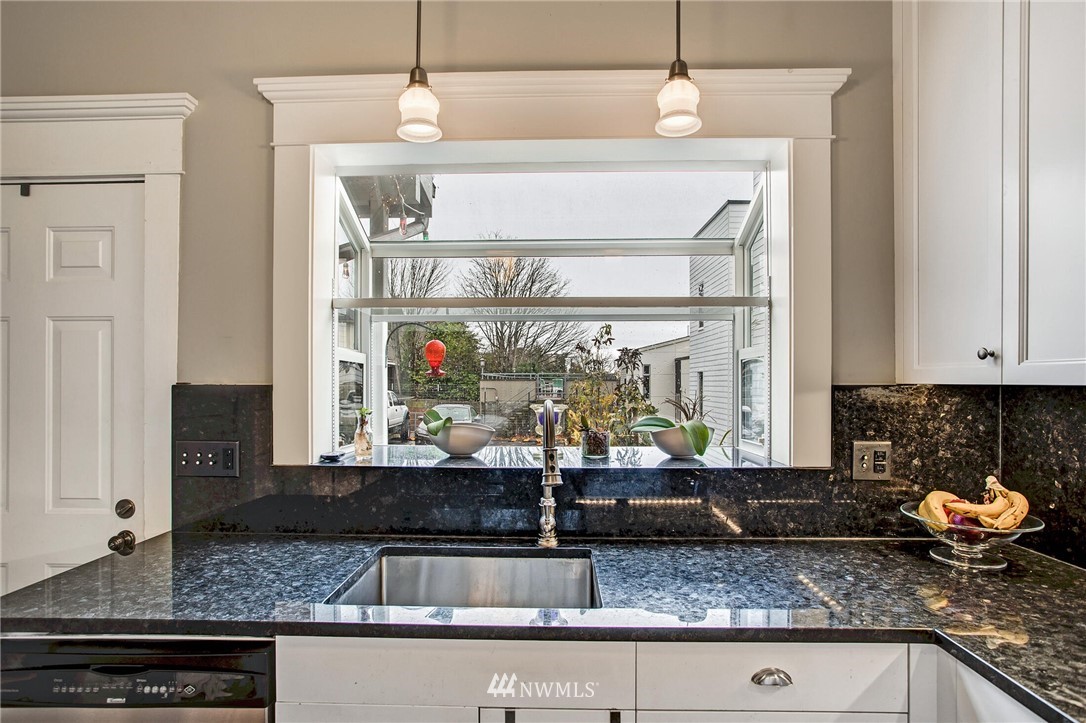 1415 East Spring Street Seattle, WA 98122 - Photo 12 of 38 a kitchen with granite countertop a sink and a stove