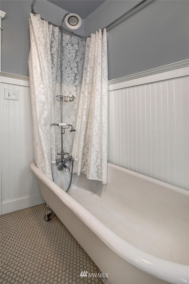 1415 East Spring Street Seattle, WA 98122 - Photo 14 of 38 a white bath tub sitting next to a shower curtain