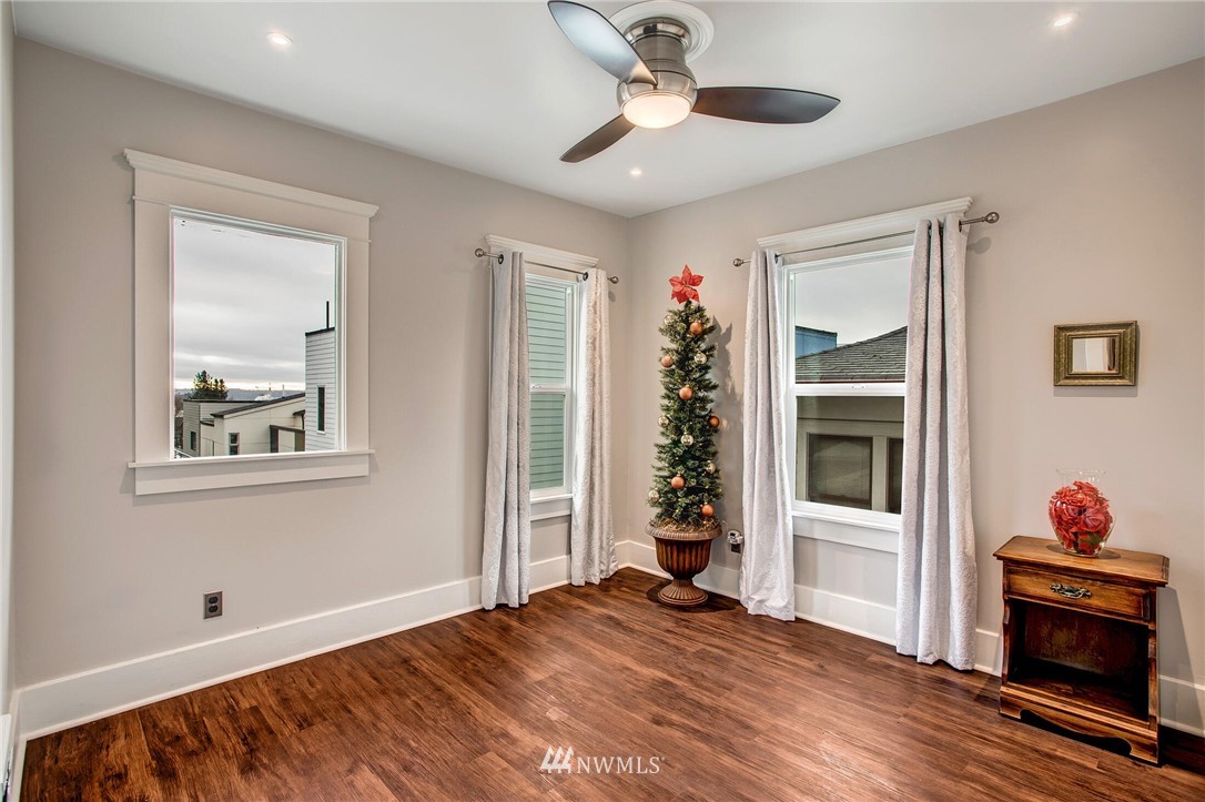 1415 East Spring Street Seattle, WA 98122 - Photo 15 of 38 a view of an empty room with a window and wooden floor