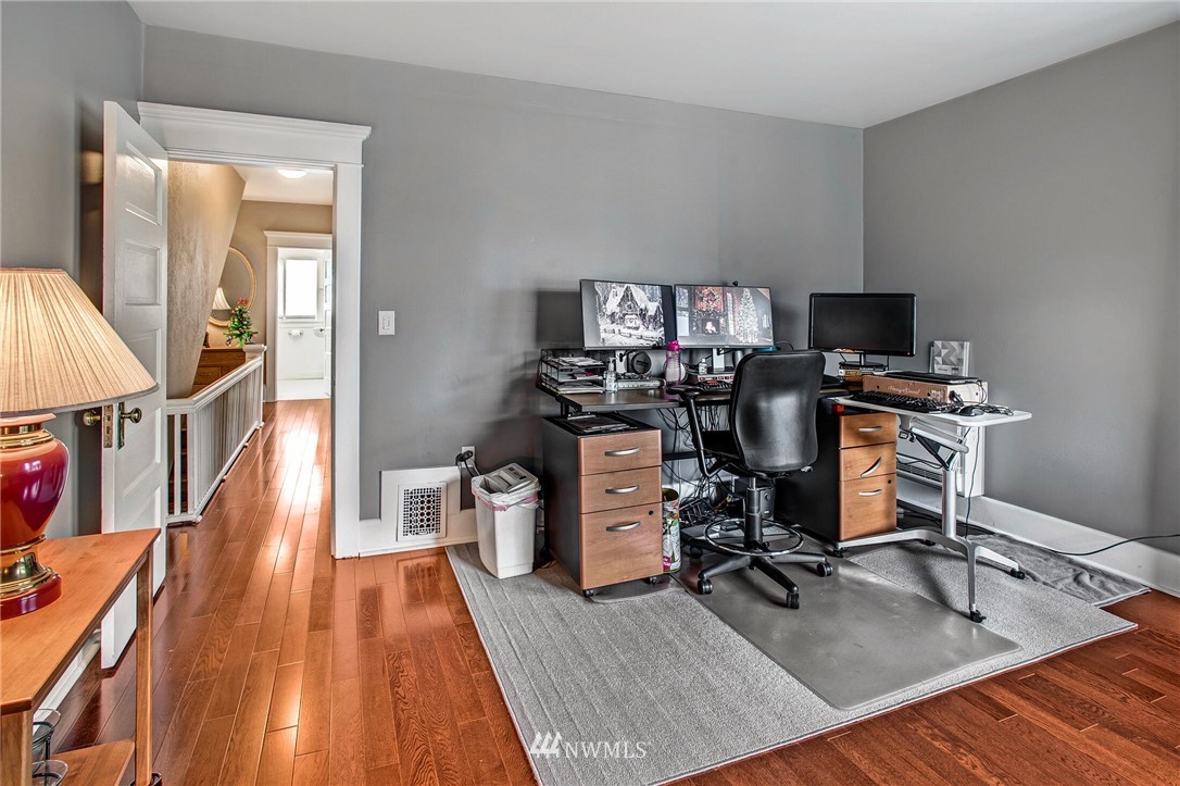 1415 East Spring Street Seattle, WA 98122 - Photo 18 of 38 a view of a workspace with furniture and wooden floor