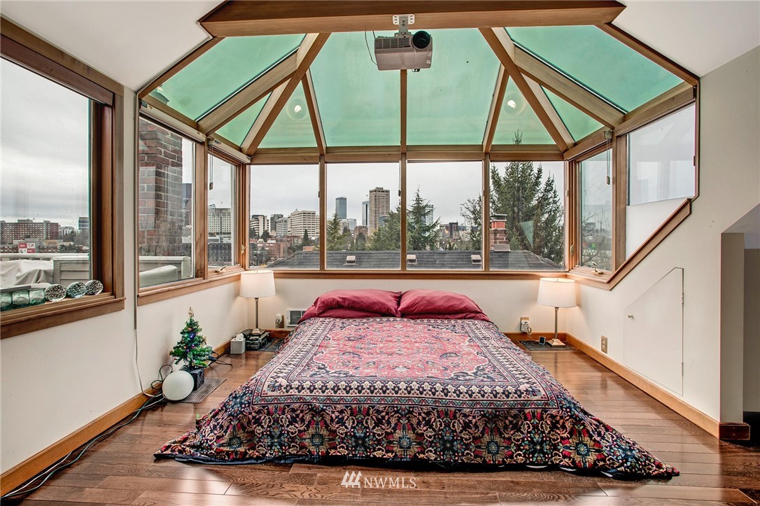 1415 East Spring Street Seattle, WA 98122 - Photo 20 of 38 a bed sitting in a bedroom next to a window