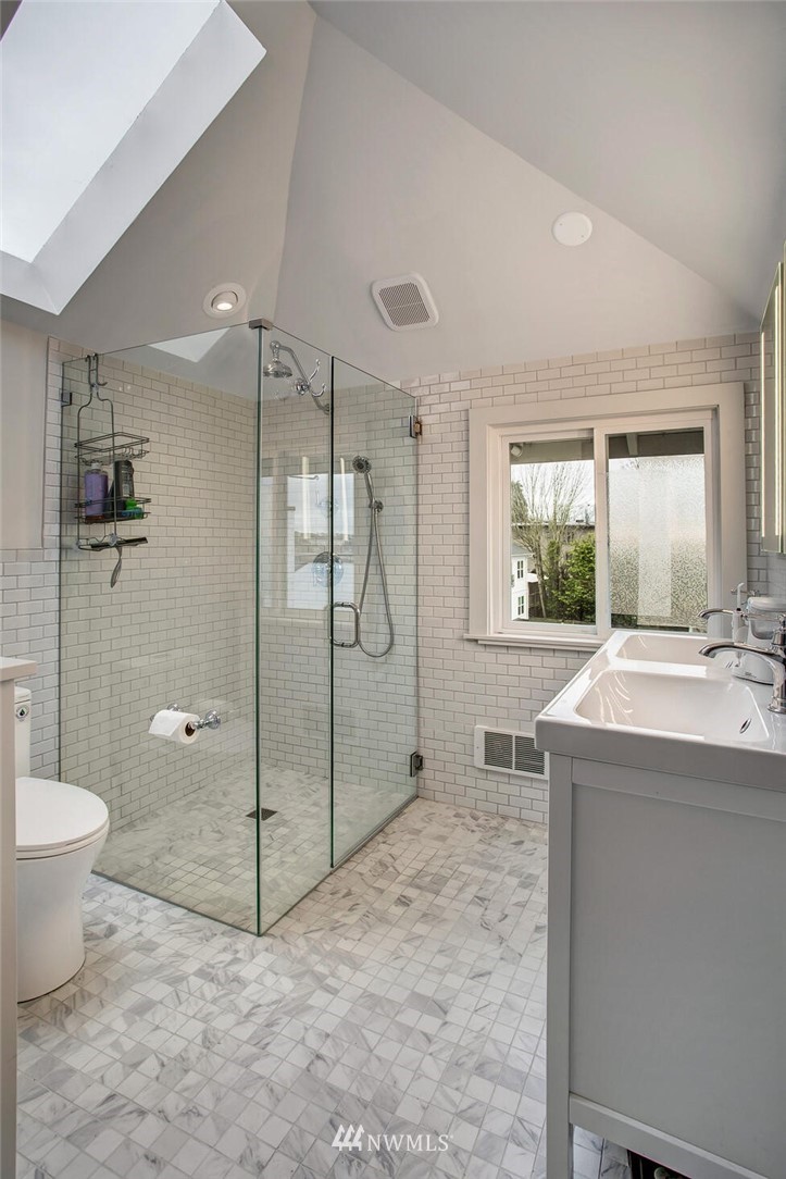 1415 East Spring Street Seattle, WA 98122 - Photo 23 of 38 a bathroom with a granite countertop sink toilet and shower