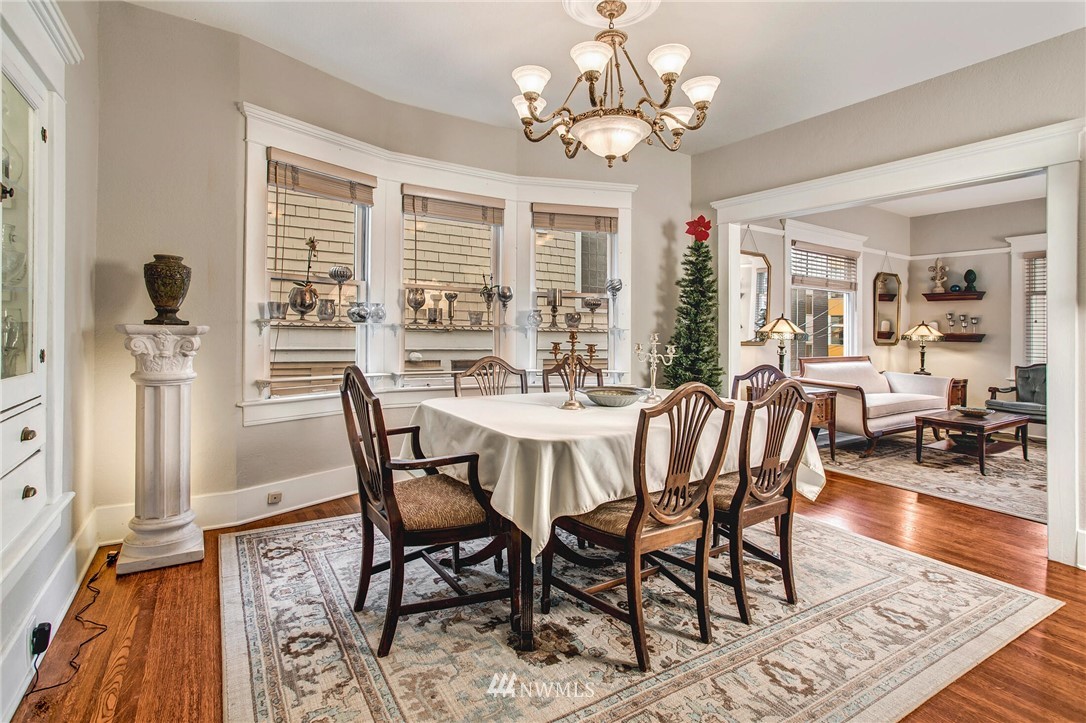 1415 East Spring Street Seattle, WA 98122 - Photo 9 of 38 a view of a dining room with furniture wooden floor and chandelier