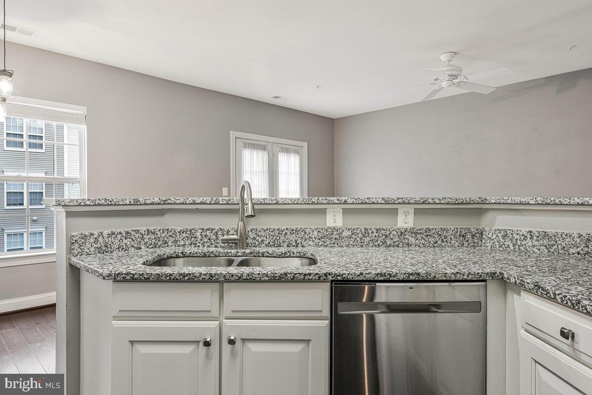8045 Gatehouse Road, Unit 17 Falls Church, VA 22042 - Photo 11 of 32 a kitchen with granite countertop a sink and cabinets