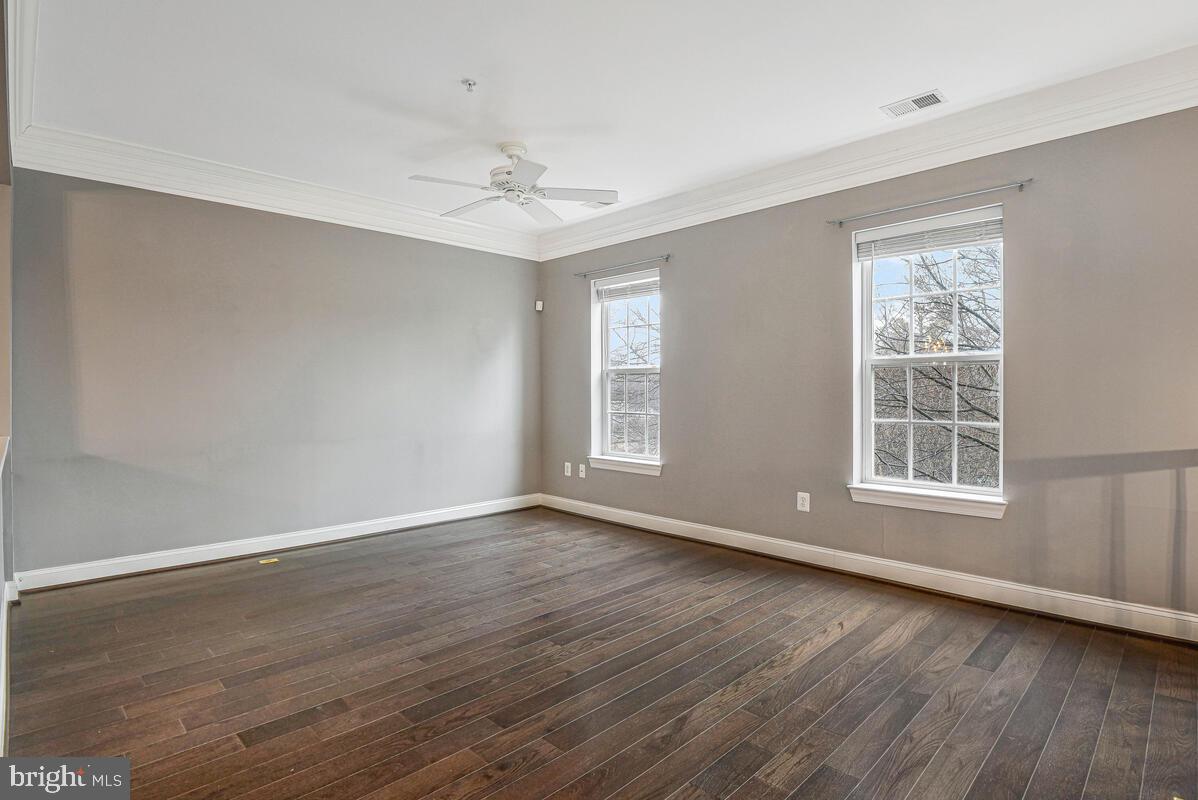 8045 Gatehouse Road, Unit 17 Falls Church, VA 22042 - Photo 2 of 32 a view of an empty room with wooden floor and a window