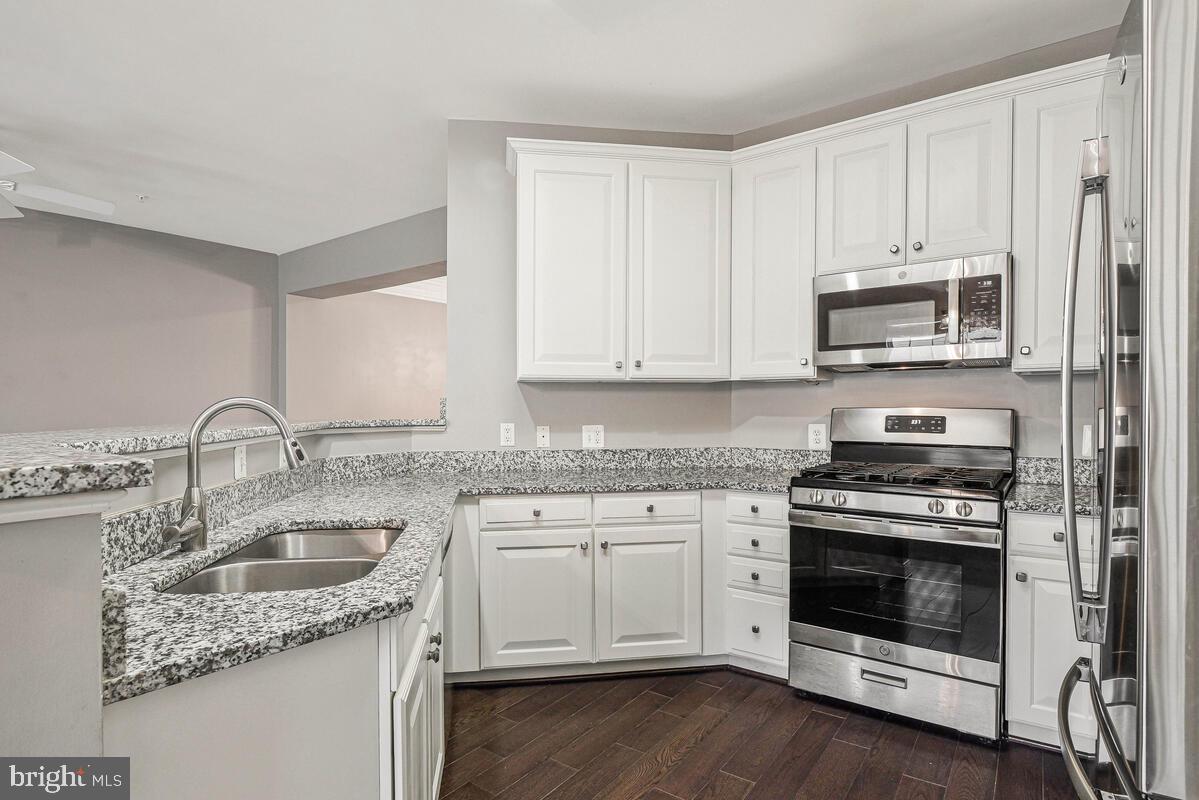 8045 Gatehouse Road, Unit 17 Falls Church, VA 22042 - Photo 10 of 32 a kitchen with appliances a sink and cabinets