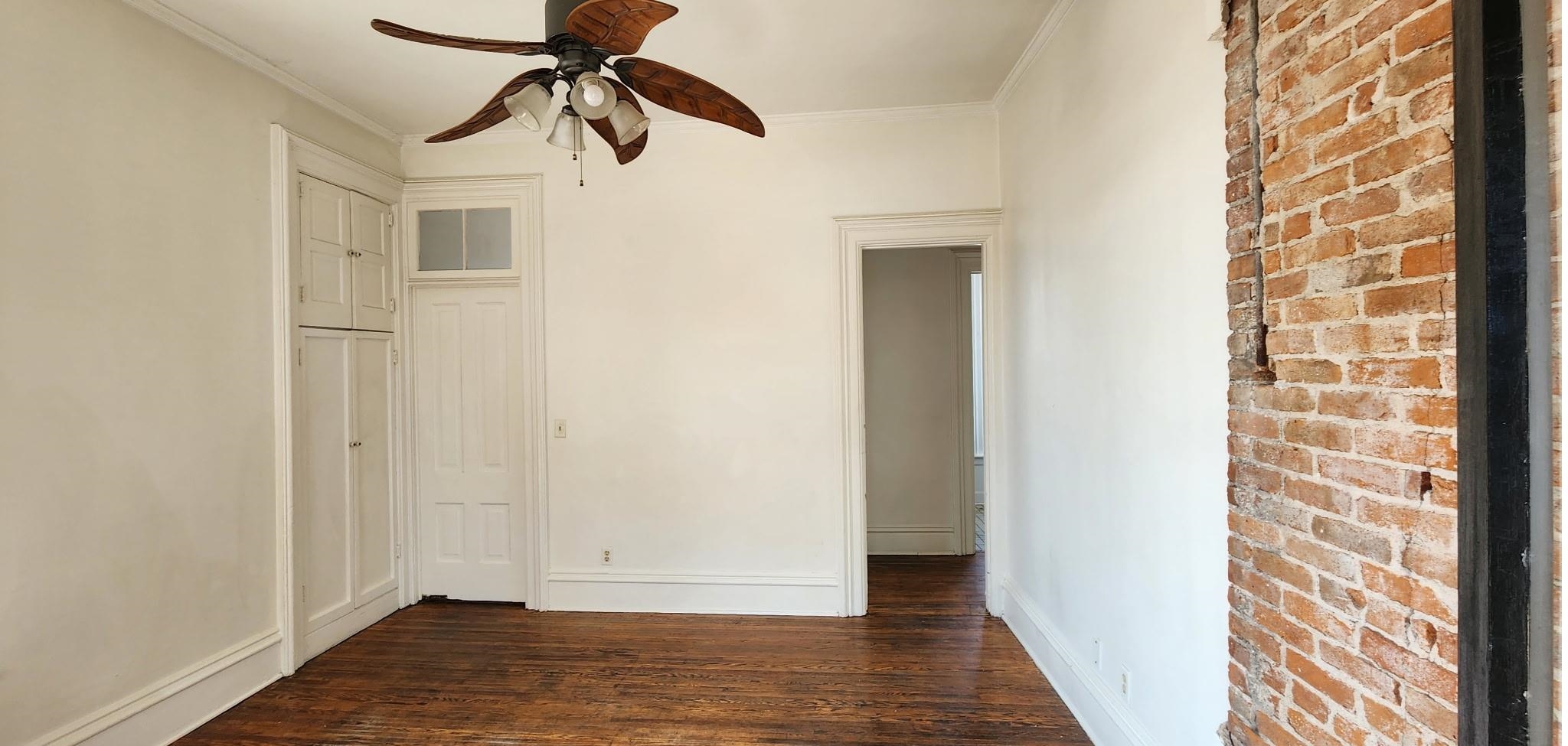 129 North 2nd Street Rockford, IL 61107 - Photo 2 of 2 a view of empty room with wooden floor and fan