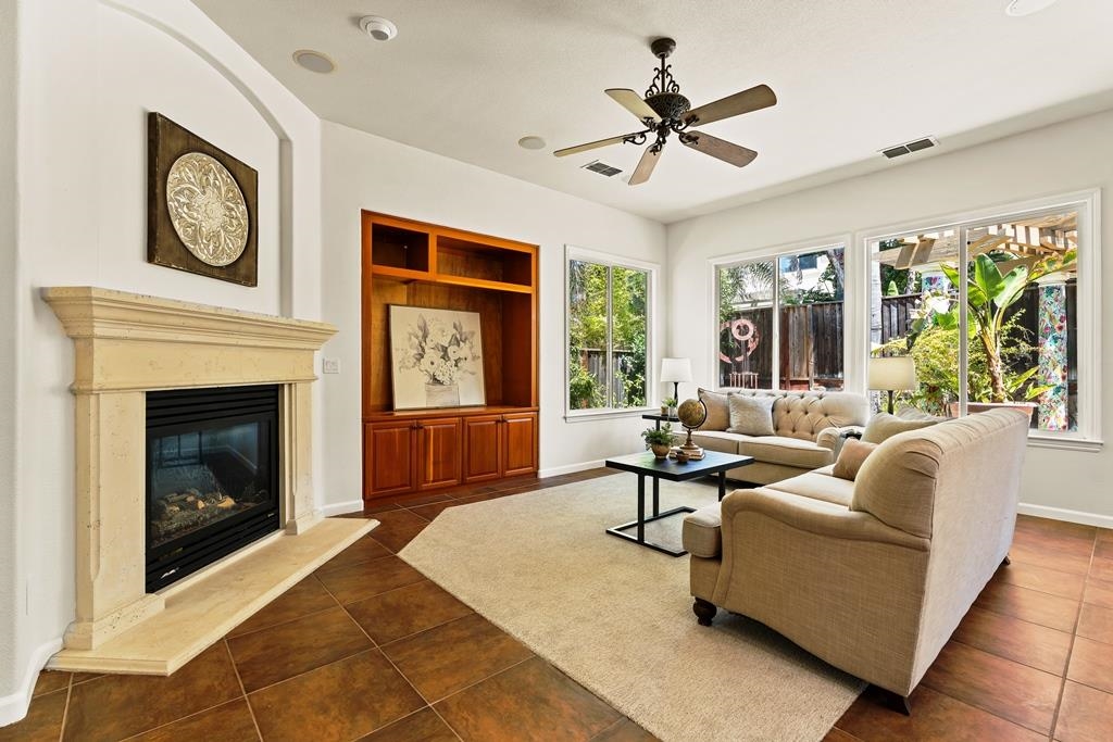 3146 Castle Rock Loop Discovery Bay, CA 94505 - Photo 12 of 49 a living room with furniture a clock and a fireplace
