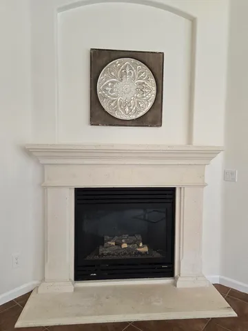 a fireplace with a clock on wall
