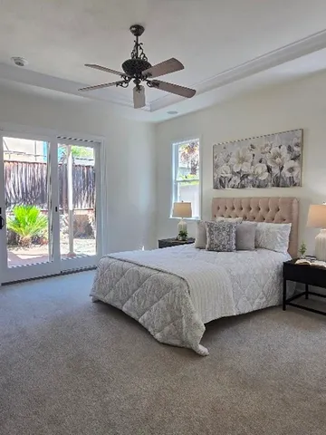 a spacious bedroom with a bed and a window