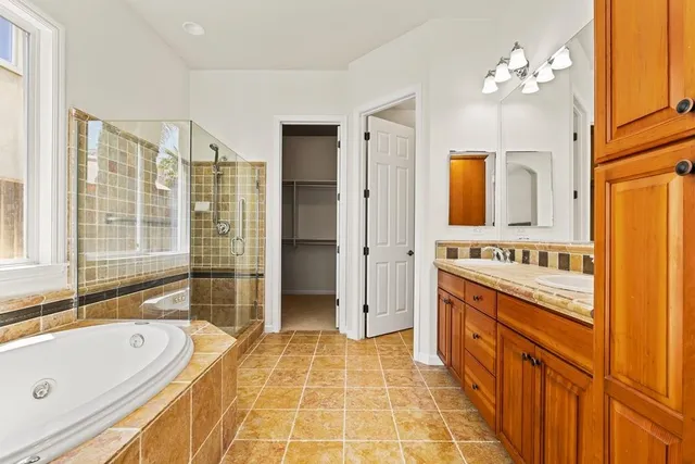 a bathroom with a tub sink and mirror