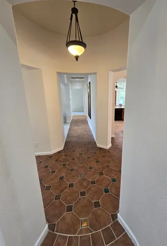a view of a hallway with a chandelier