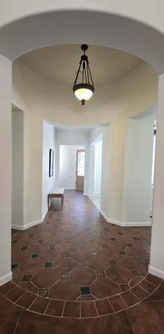a view of a livingroom with wooden floor and a ceiling fan