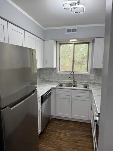 a kitchen with a sink cabinets and window