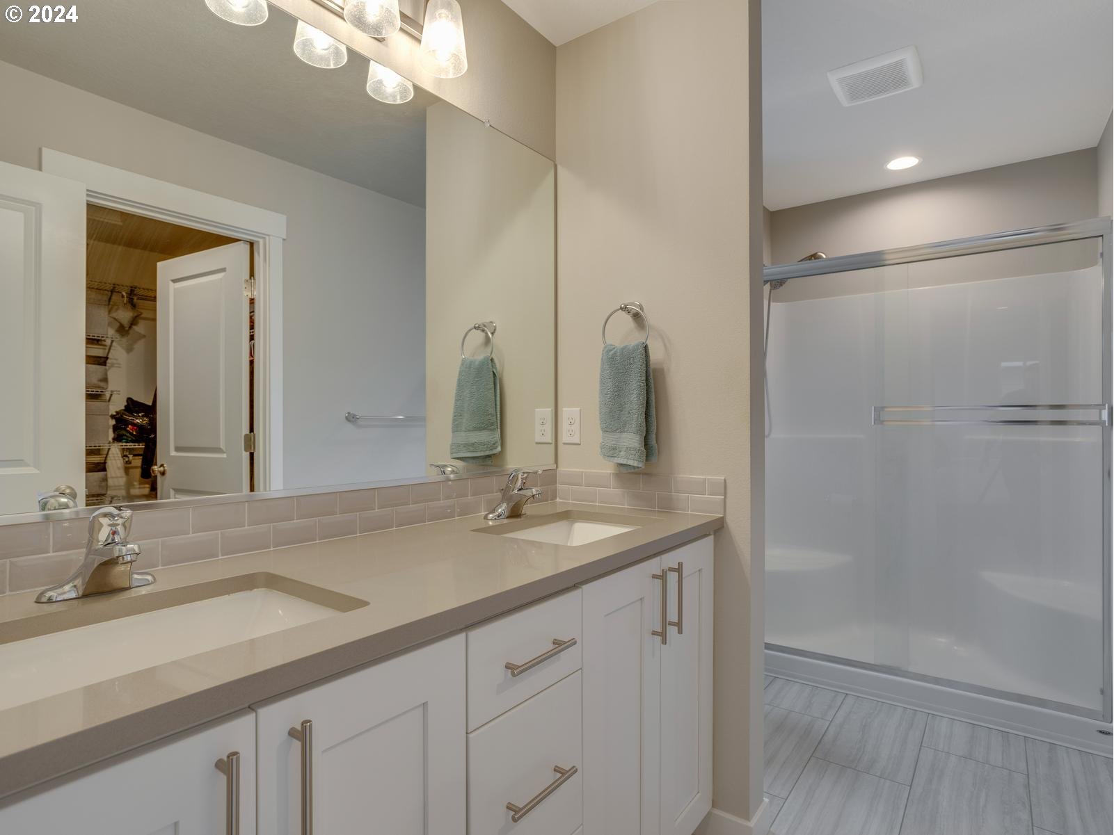 8708 North 3rd Way Ridgefield, WA 98642 - Photo 14 of 30 a bathroom with a double vanity sink and a mirror