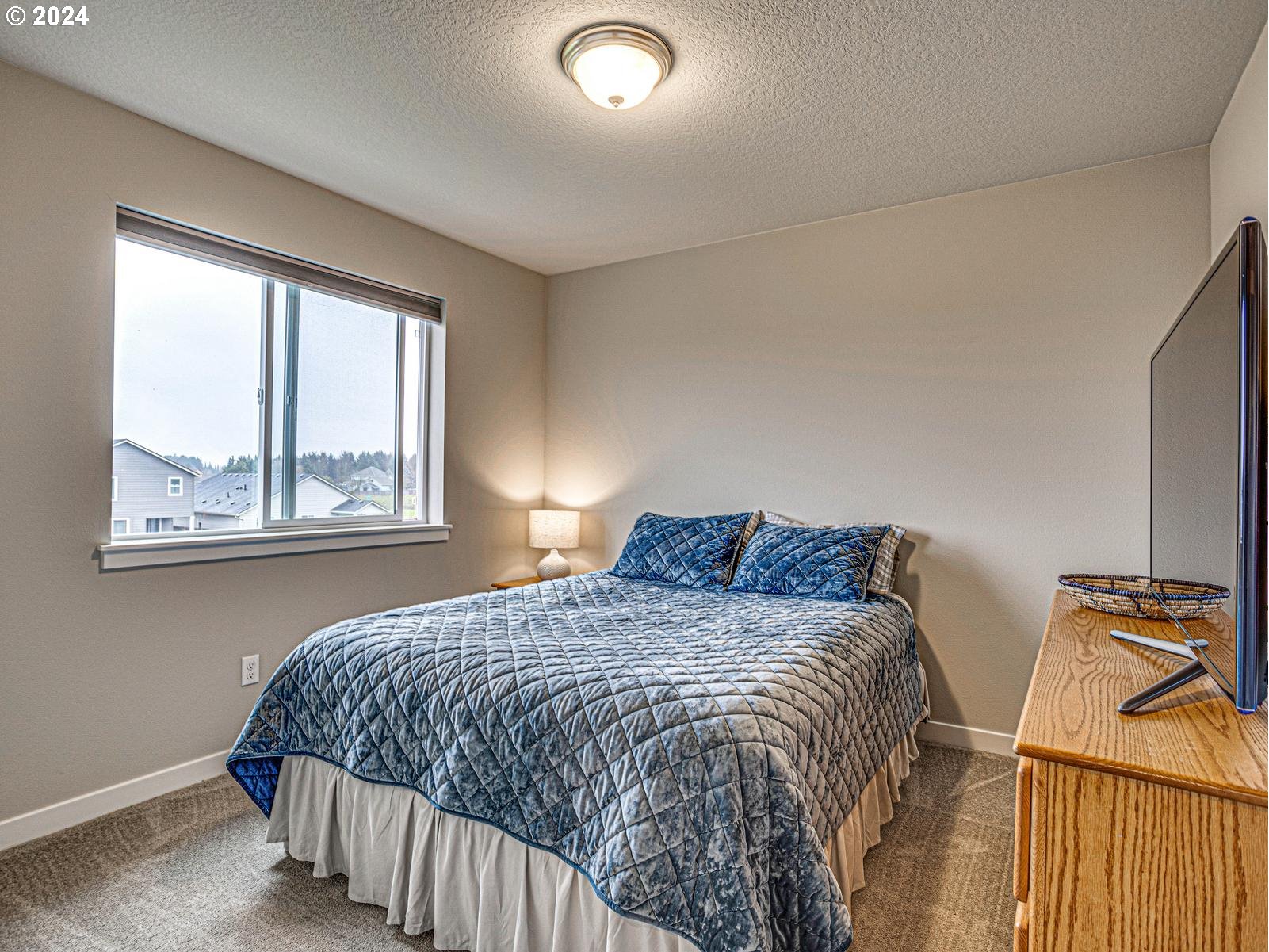 8708 North 3rd Way Ridgefield, WA 98642 - Photo 17 of 30 a bedroom with a bed and a window