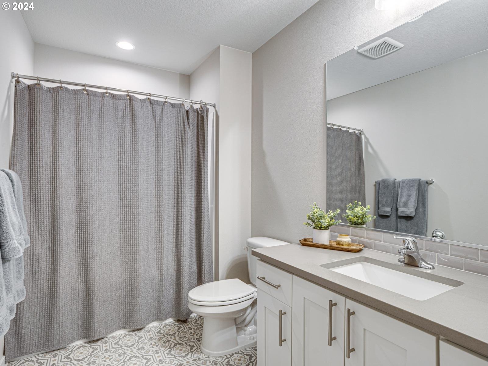 8708 North 3rd Way Ridgefield, WA 98642 - Photo 19 of 30 a bathroom with a granite countertop sink and a mirror