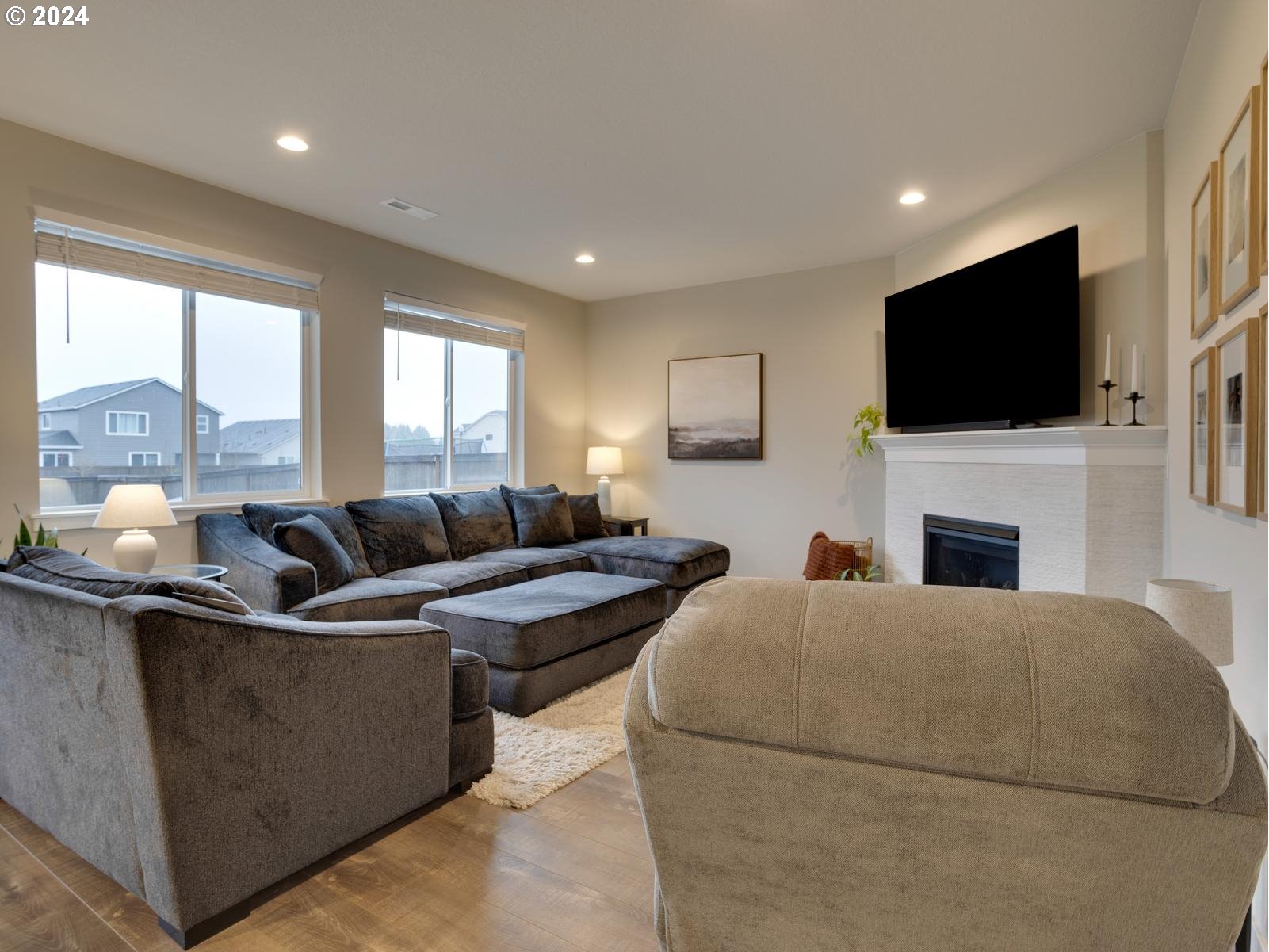 8708 North 3rd Way Ridgefield, WA 98642 - Photo 6 of 30 a living room with furniture a flat screen tv and a fireplace