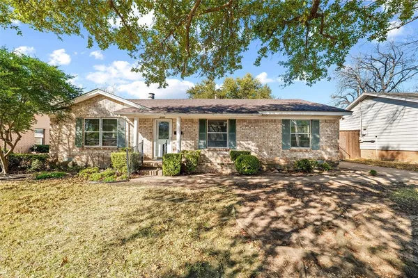 a front view of a house with a small yard