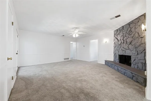 a view of an empty room with a fireplace