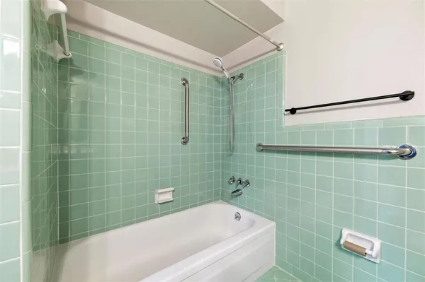 a bathroom with a bathtub and shower