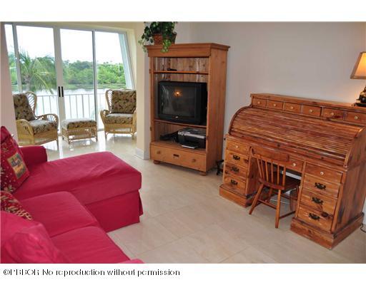 2165 Ibis Isle Road, Unit 15 Palm Beach, FL 33480 - Photo 11 of 14 a living room with furniture and a flat screen tv