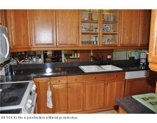 2165 Ibis Isle Road, Unit 15 Palm Beach, FL 33480 - Photo 8 of 14 a kitchen with a sink and cabinets
