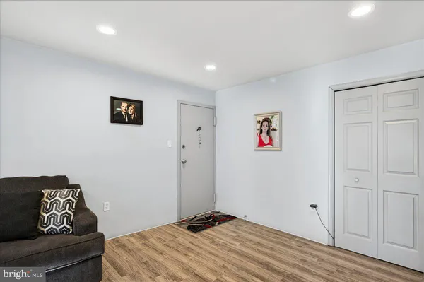 a living room with furniture wooden floor and a large window