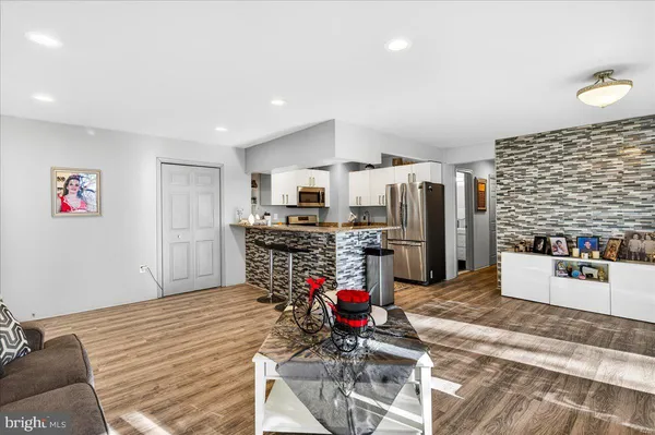 a kitchen with stainless steel appliances kitchen island granite countertop a refrigerator and a stove top oven