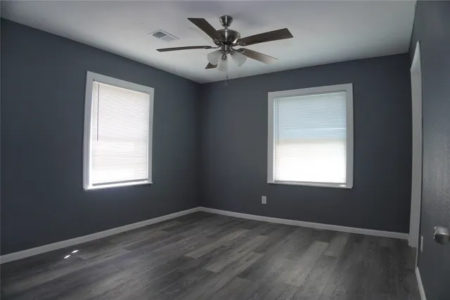 a view of a livingroom with a ceiling fan and window