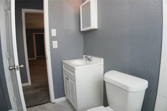 a white toilet sitting next to a sink