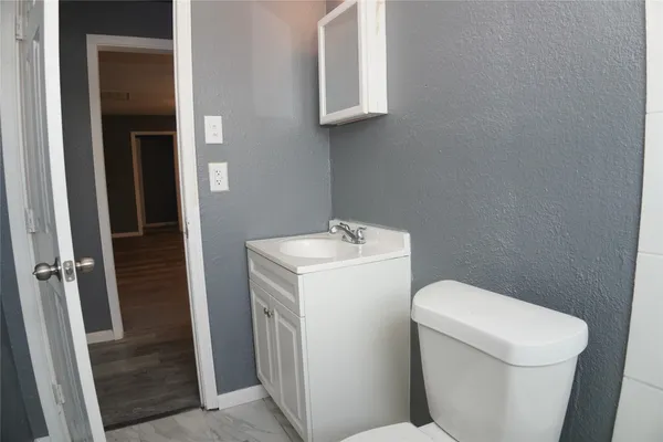 a white toilet sitting next to a sink