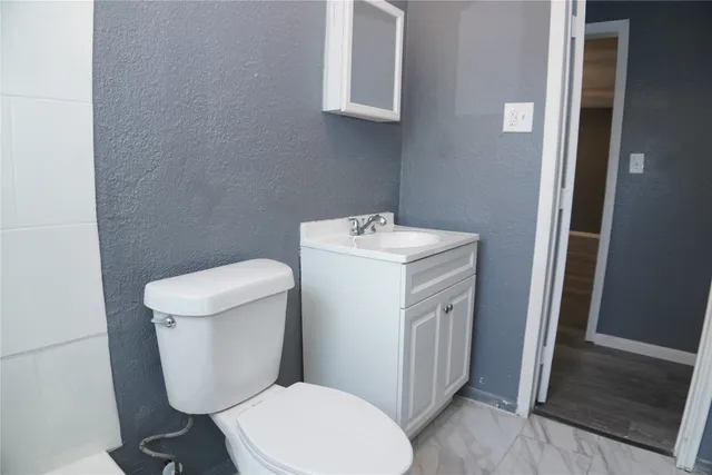 a white toilet sitting next to a bathroom sink
