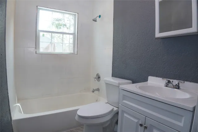 a bathroom with a sink toilet and bathtub
