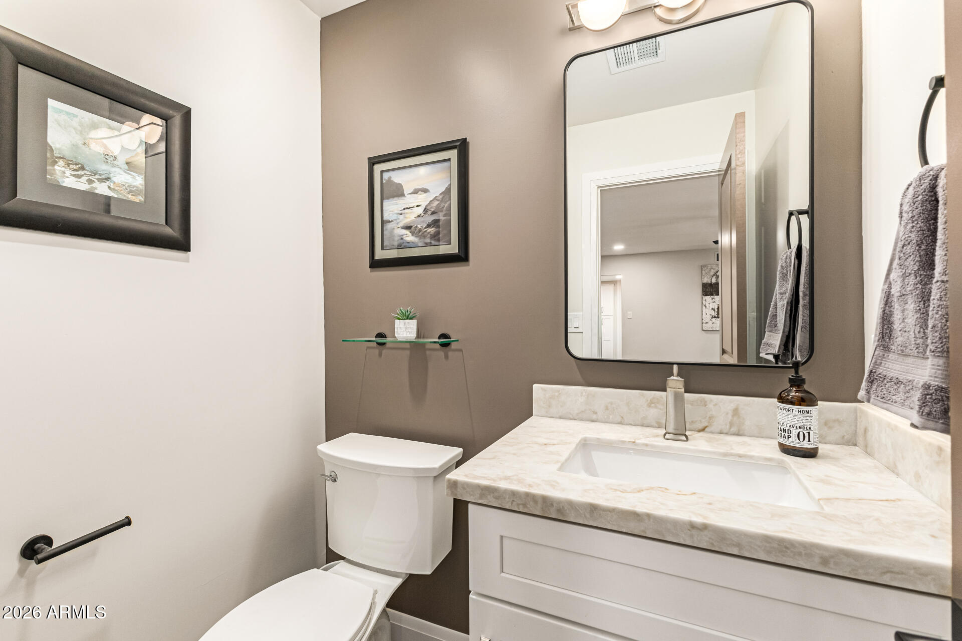 2901 East Las Rocas Drive Phoenix, AZ 85028 - Photo 33 of 47 a bathroom with a granite countertop toilet a sink and mirror