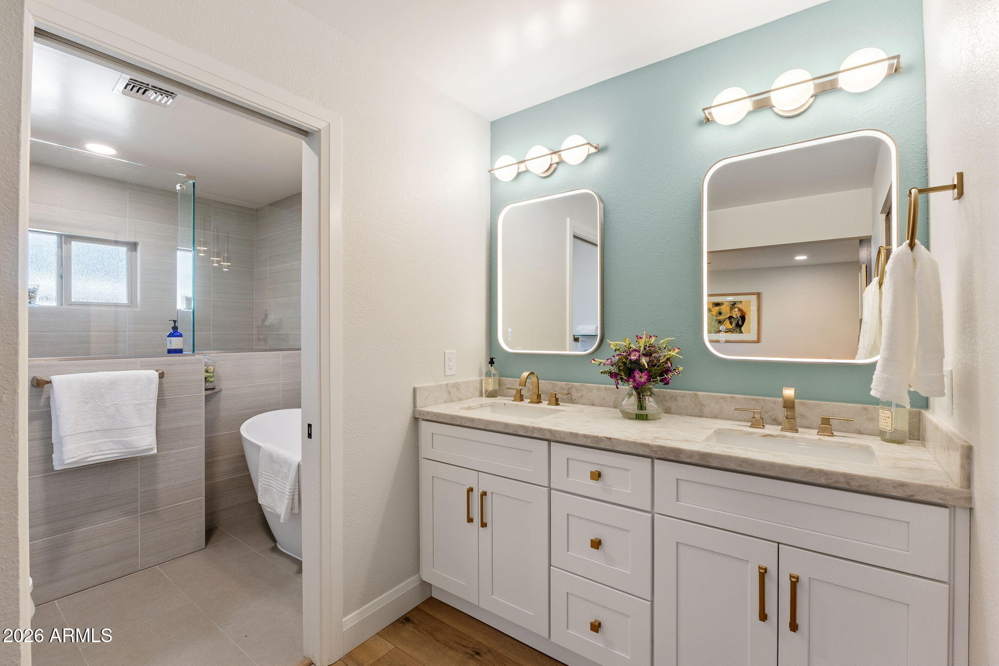 2901 East Las Rocas Drive Phoenix, AZ 85028 - Photo 10 of 47 a en suite bathroom with double vanity a mirror and a bathtub