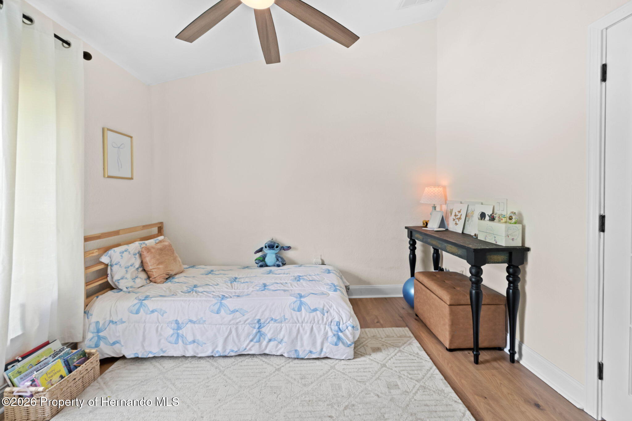 14220 Ermine Owl Road Brooksville, FL 34614 - Photo 36 of 54 a bedroom with a bed and wooden floor