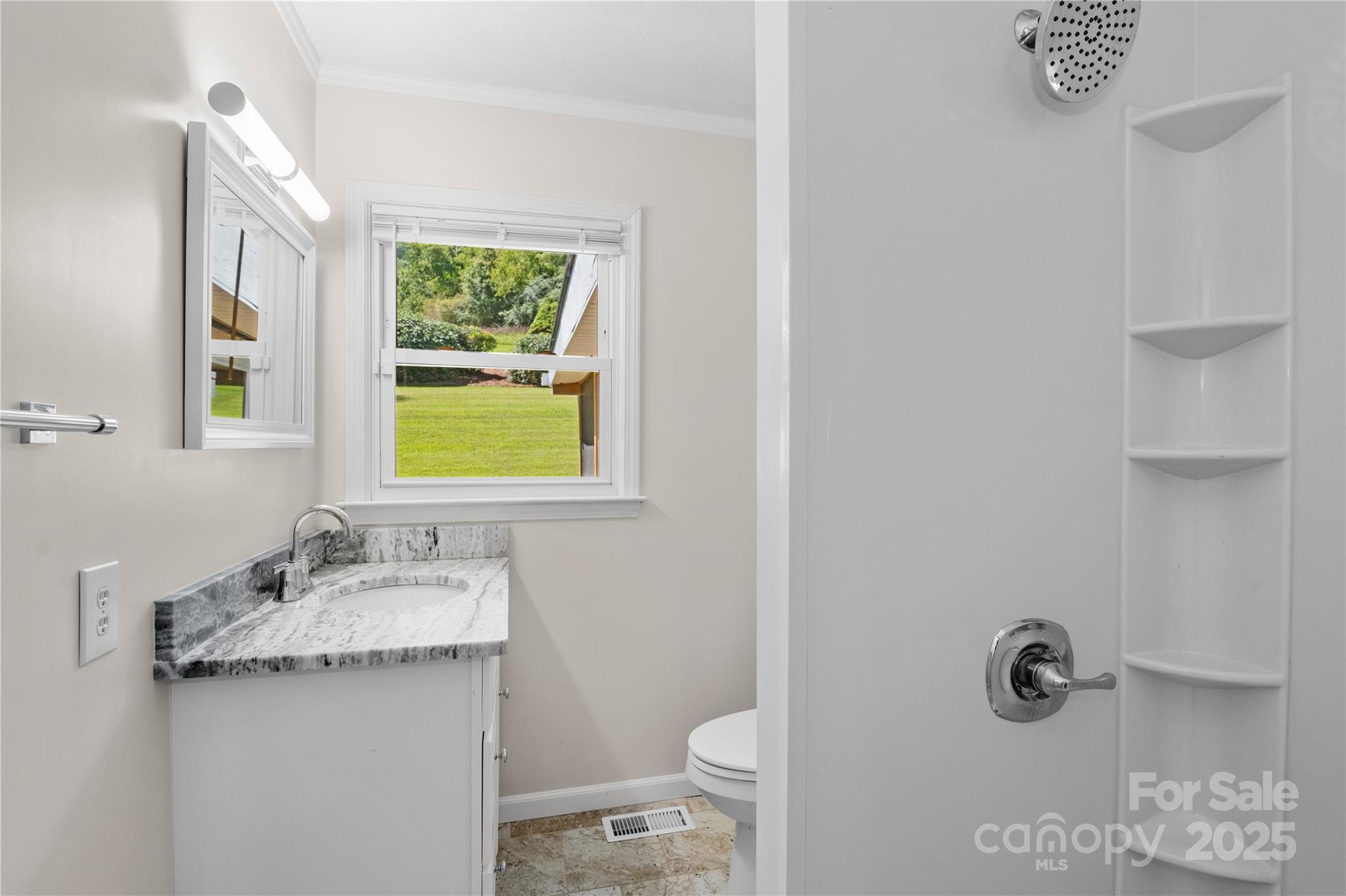 111 Curtis Creek Road Candler, NC 28715 - Photo 14 of 28 a bathroom with a granite countertop sink a toilet and a mirror