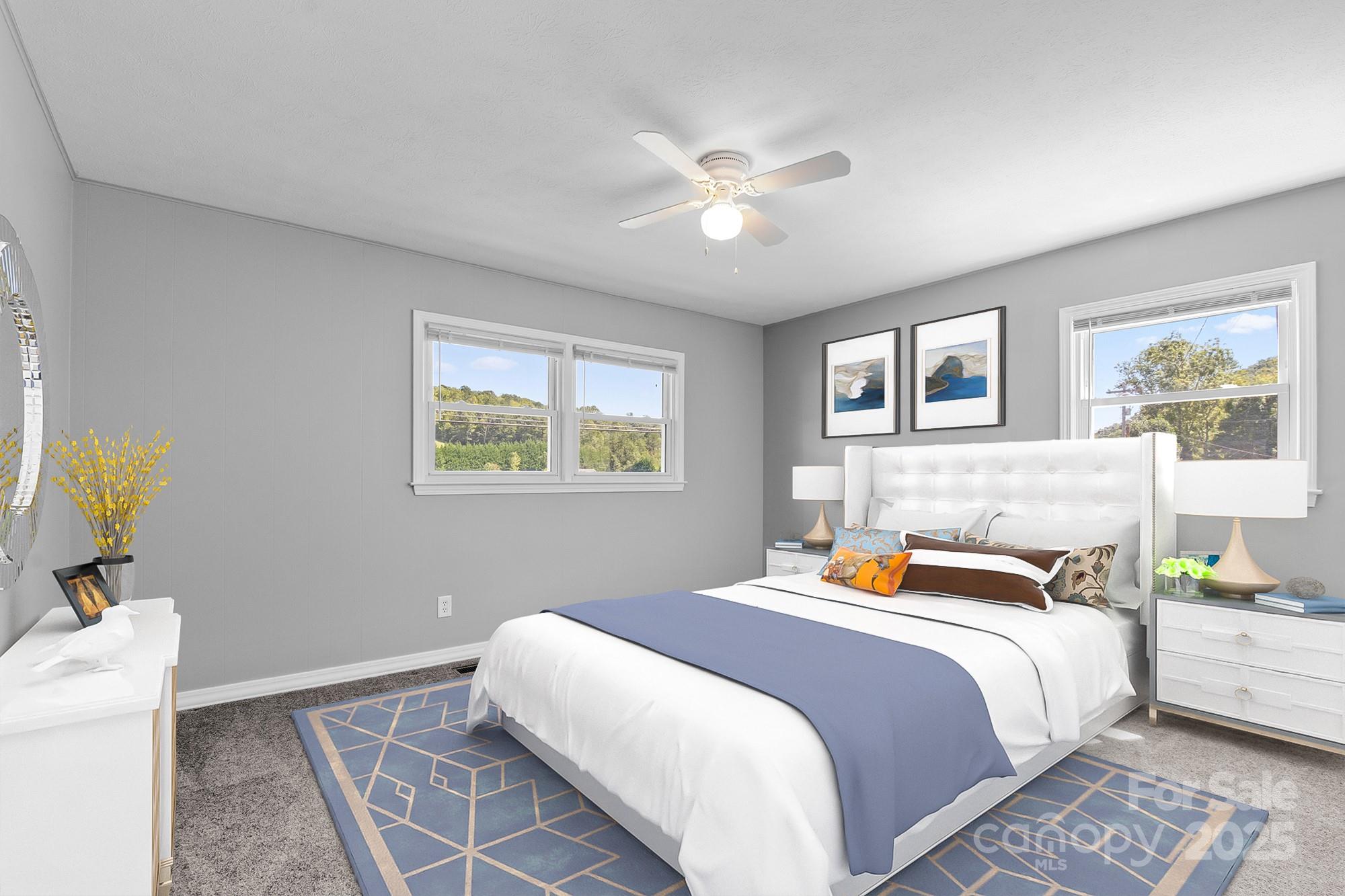 111 Curtis Creek Road Candler, NC 28715 - Photo 18 of 28 a bedroom with a bed and a chandelier